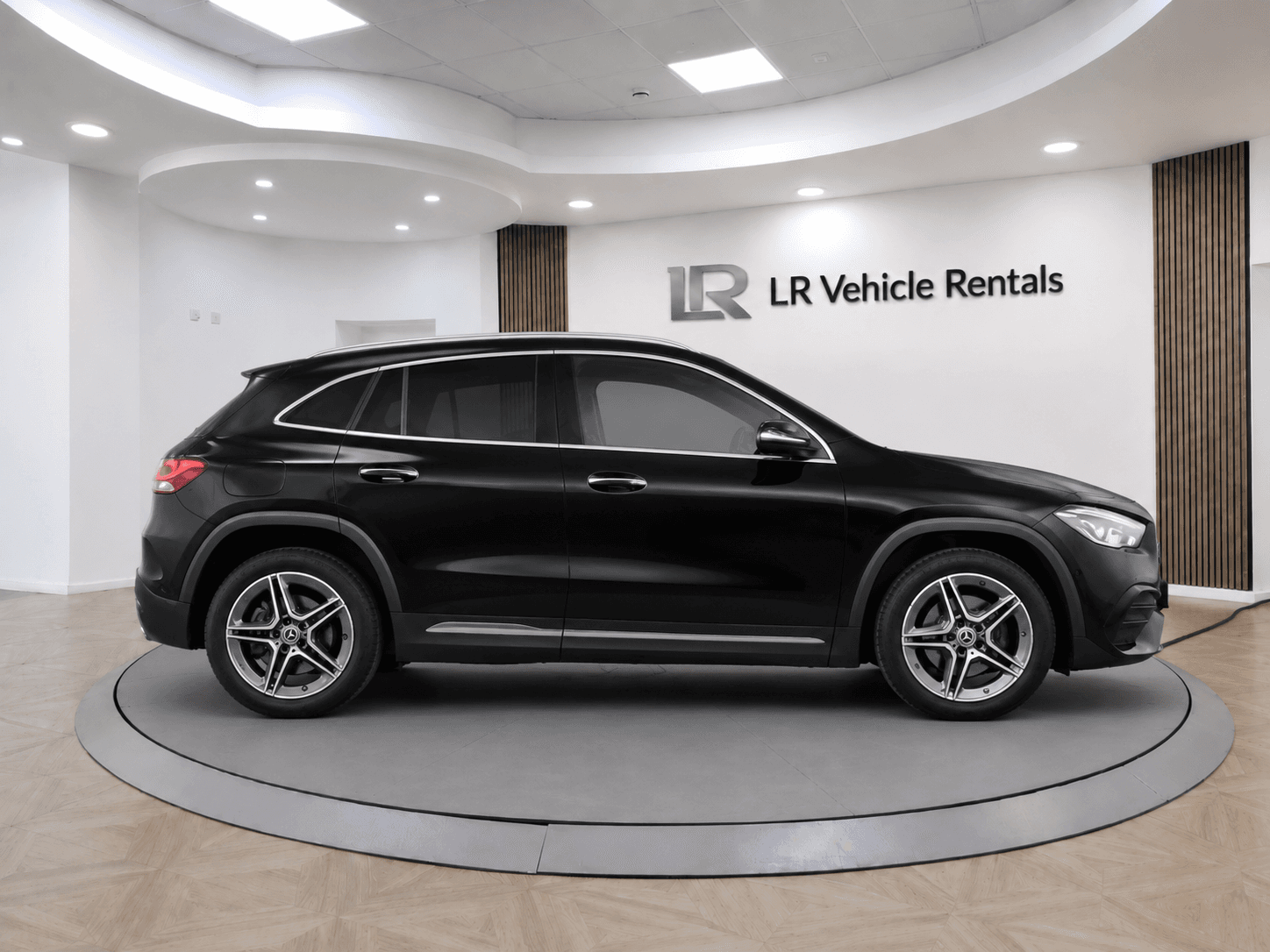 Black Mercedes-Benz GLA in profile, showing the raised SUV stance and AMG alloy wheels